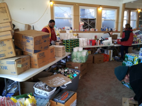 Volunteers setting up supplies in the chapel at Sea Gate